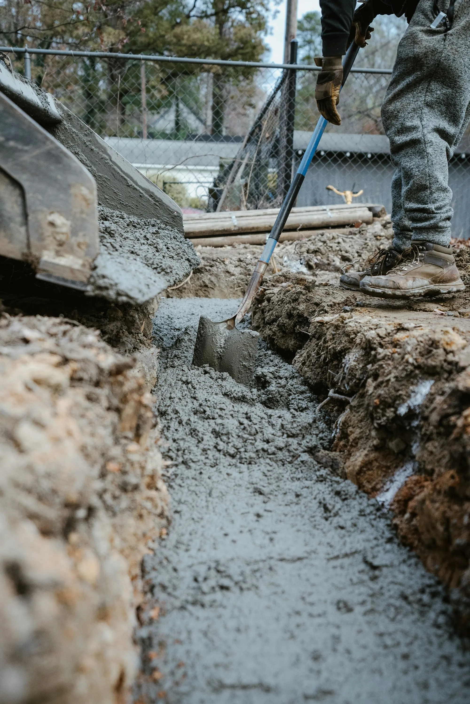 Concrete being poured into a footing trench