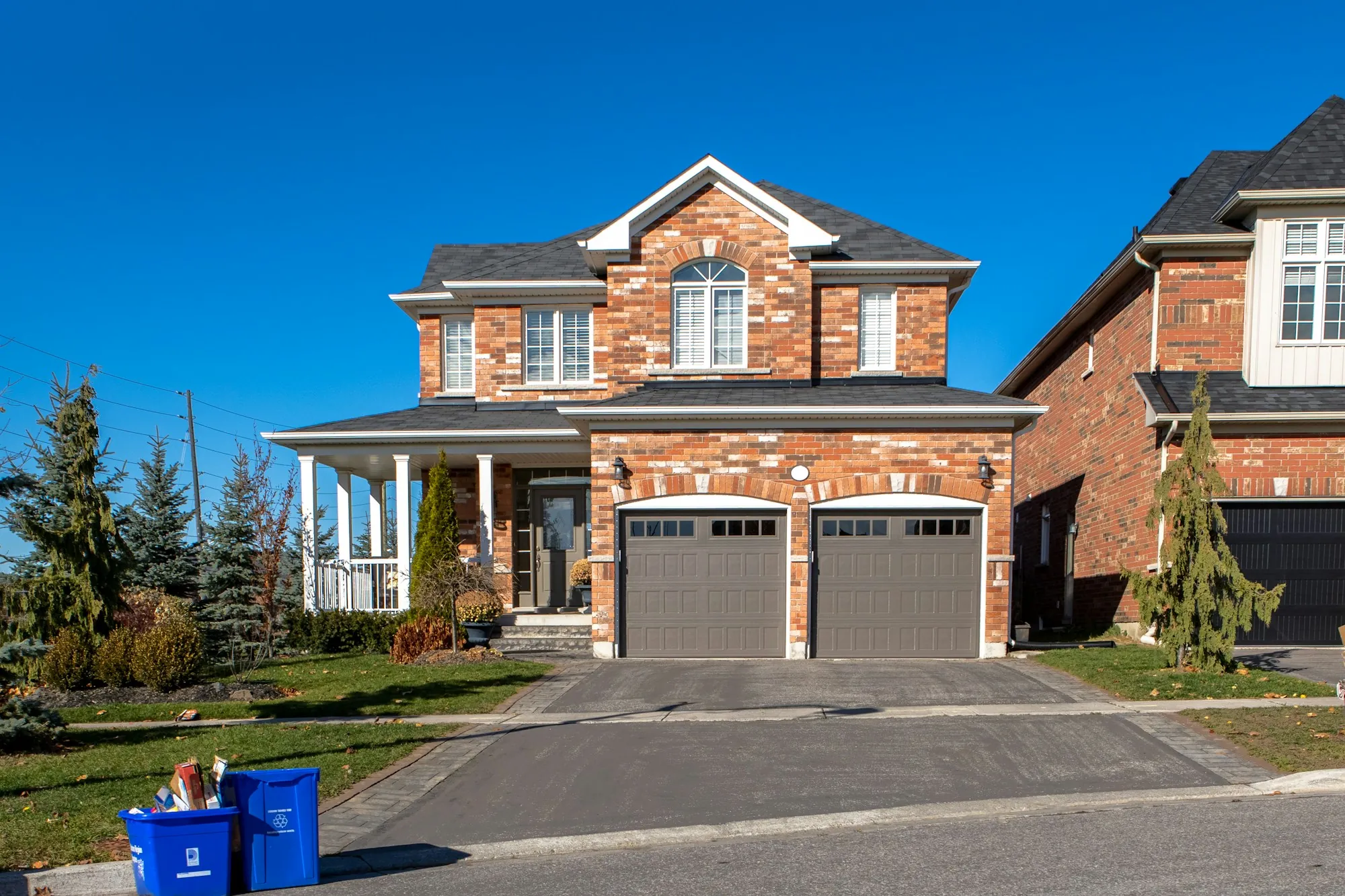 Brick two-story home with a double garage and driveway