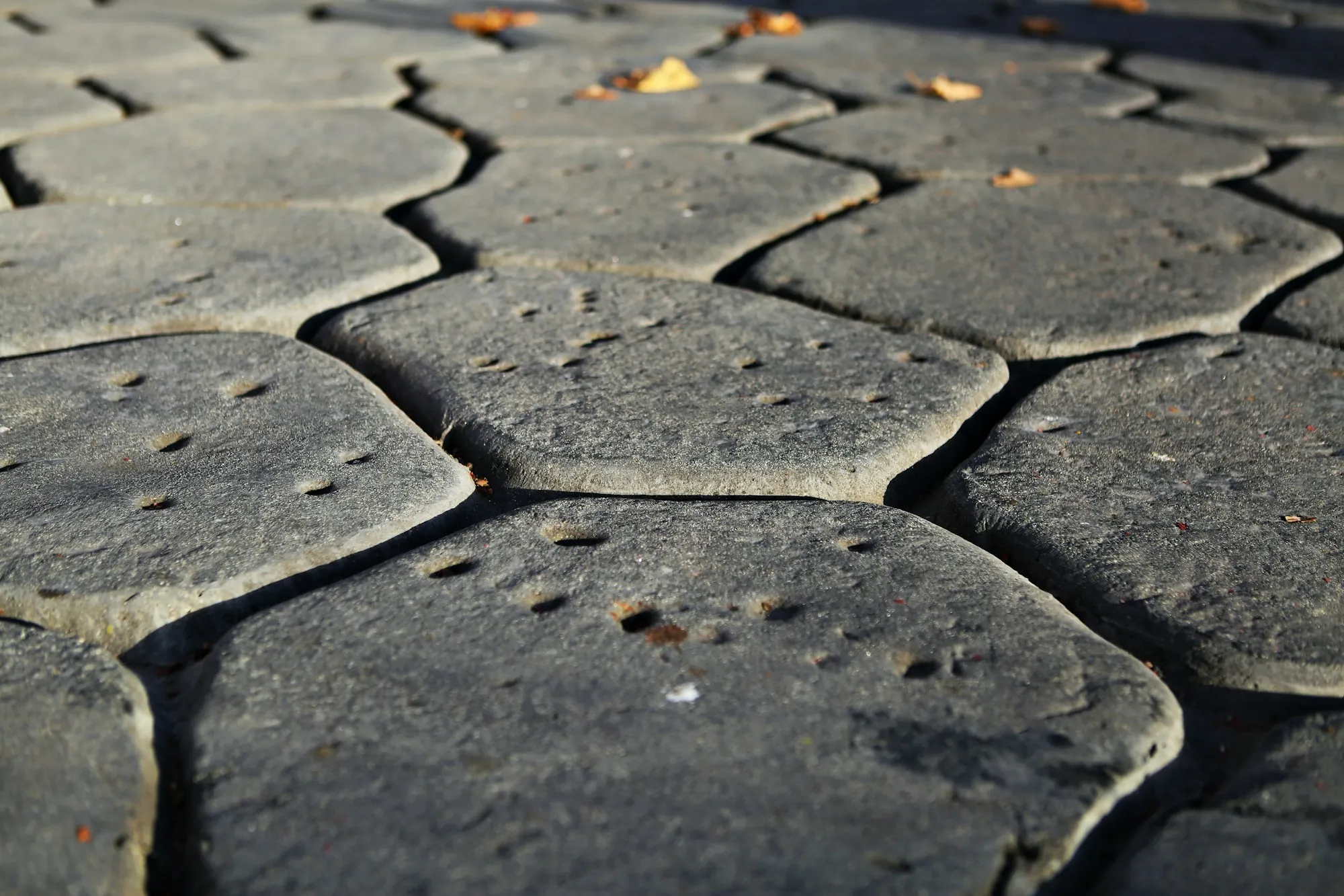 Dark stamped concrete with a rounded cobblestone pattern